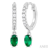 1/8 ctw Petite 5X3MM Oval Cut Emerald and Round Cut Diamond Precious Fashion Huggies in 10K White Gold